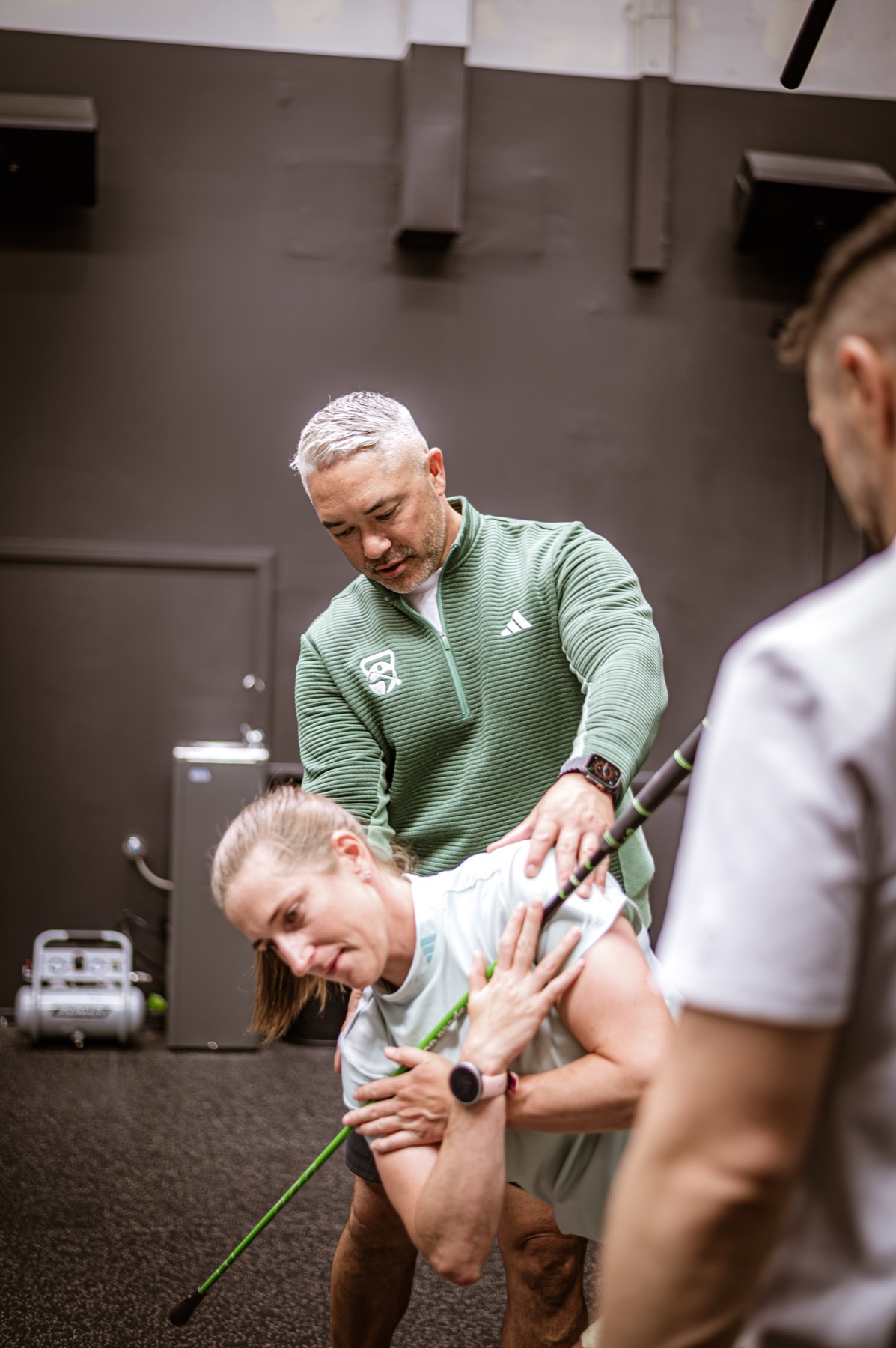 Golfers Hub practitioners collaborating during a golf performance session